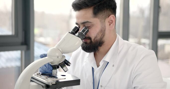 Lab male worker do research with microscope