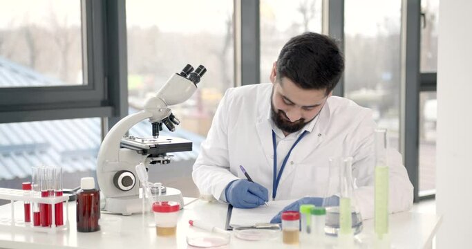 Lab male worker do research with microscope