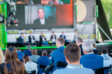 Participants of open air conference listening to speaker