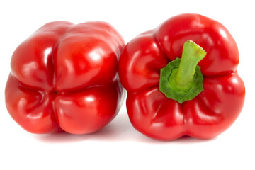 Two red sweet peppers isolated on white background. Paprika close-up.