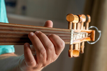 hands of a musician playing the lute in Greece