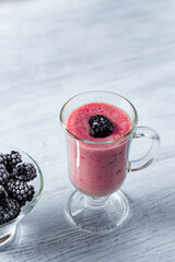 Fototapeta na wymiar Banana-blackberry smoothie made from frozen fruits.