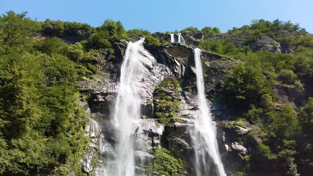 Water stream running from the beautiful Acquafraggia waterfall in Piuro, in the Bregaglia valley in Italy, before the ascent to the Maloja pass. It is a beautiful sunny summer day.