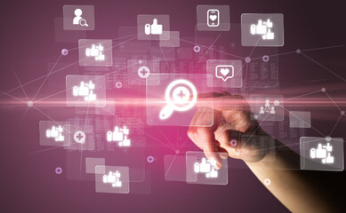 Hand pressing social media multimedia application screen with media icons on futuristic concept