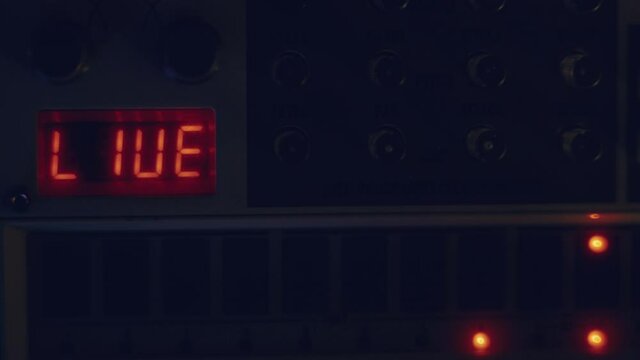 drum machine synthesizer close-up
the words LIVE are seen on the screen while the sequencer is running a base
