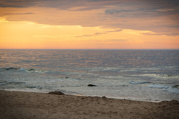 View on landscape of sunset, sea with wave and beach. Travel concept. Summer time
