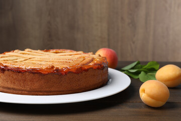 Tasty apricot pie on wooden table, closeup