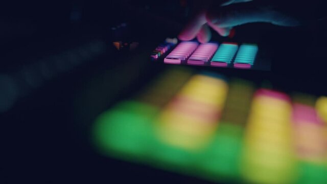 musician playing Synthesizer sequencers
Close-up of a synthesizer pad, showing a grid with a running timeline. The musician plays the pads and changes the notes on the sequencer
