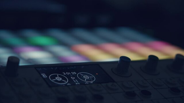 musician playing Synthesizer sequencers
Close-up of a synthesizer pad, showing a grid with a running timeline. The musician plays the pads and changes the notes of the grid