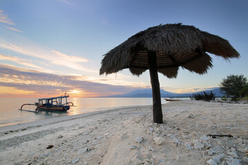umbrella and boat on a sandy beach