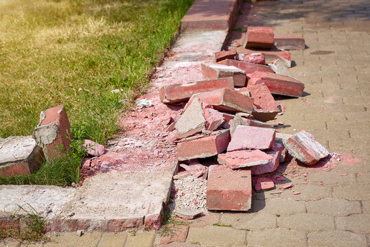 Road Work, Curb Replacement, Urban Landscape Edging. Broken Sidewalk Border. Damaged Brick Sidewalk Border, Pavement Edges.