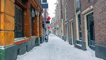 Fototapeta na wymiar Snowy Red LIght District in winter in Amsterdam the Netherlands