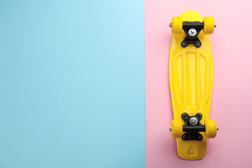 Yellow skateboard on color background, top view. Space for text