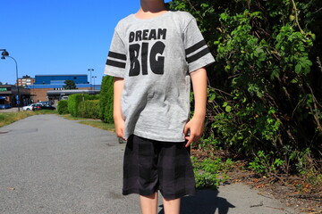 Obraz premium Small boy with a big dream. Faceless photo. Nice and warm summer day outside. Concept of future dreams. Stockholm, Sweden, Europe.