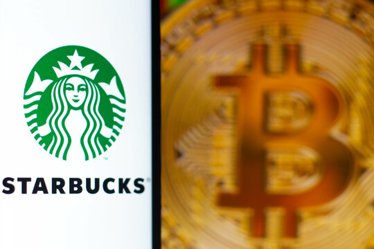 August 7, 2021, Brazil. In this photo illustration the Starbucks logo seen displayed on a smartphone. In the background, a bitcoin cryptocurrency is displayed.