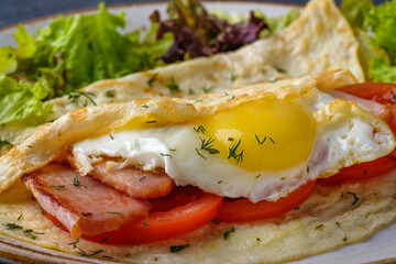 Omelette with bacon, tomatoes and egg. Macro view, closeup