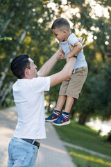 Father is having fun with his son in his arms.