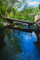 wooden bridge through  on a small mountain river