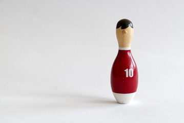a wooden puppet in the shape of a bowling pin with a number ten shirt