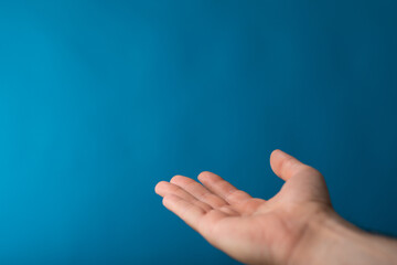 male  shows outstretched hand with open palm