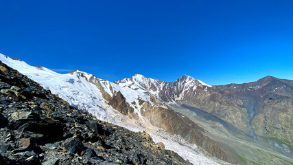 Hike across the Caucasus. Snow-capped mountains and inaccessible rocks. Mountain landscape of North Ossetia.