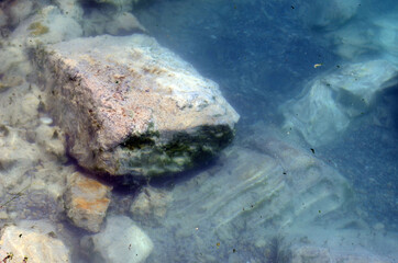 Ruins of ancient column and construction blocks of antique city Hierapolis, in Pamukkale, Turkey under water.