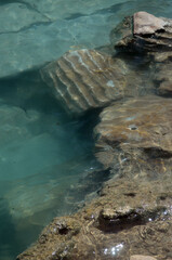 Ruins of ancient column and construction blocks of antique city Hierapolis, in Pamukkale, Turkey under water.