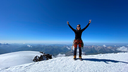 Happy climber on the top of Mount Kazbek. Climbing Kazbek from the north, from Russia.