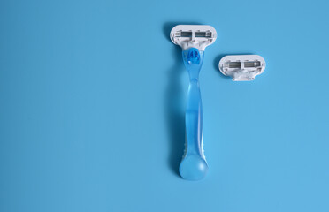 Shaving razor for women, on a blue background.