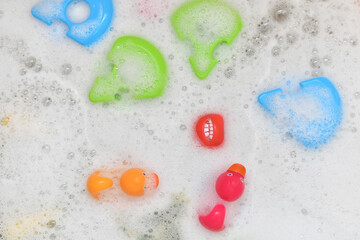Rubber multicolored toys in a bubble bath
