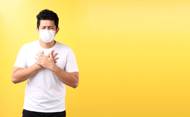 Asian man feel pain on lung and wear protective mask pollution or transmissible infectious diseas...