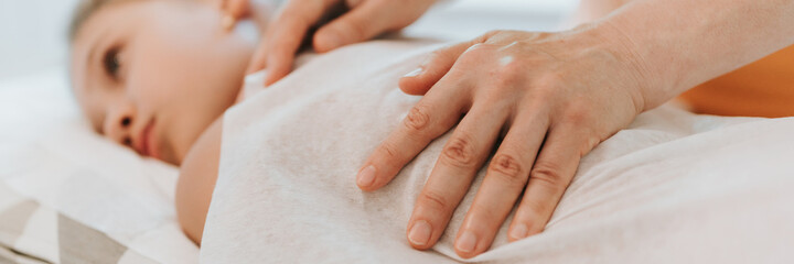 doctor osteopath hands does physiological and emotional therapy for eight year old kid girl. pediatric osteopathy treatment session. alternative medicine. taking care of the child's health. banner