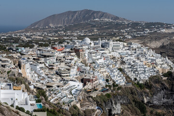 White top of buildings in Santorini, Greece with blue sky in a sunny warm day in July 2021.