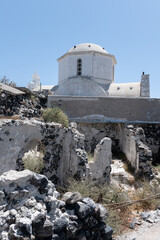 White and blue top of buildings in Pyrgos Santorini, Greece with blue sky in a sunny warm day in July 2021.