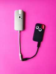 usb flash drive thunderbolt relationship in a flat Pink background. Funny gadgets with googles. LOVE technology.