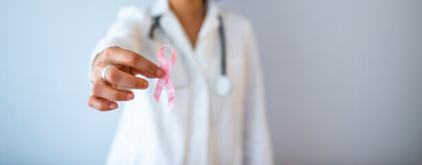 October Breast Cancer Awareness month, Woman holding Pink Ribbon for supporting people living and...