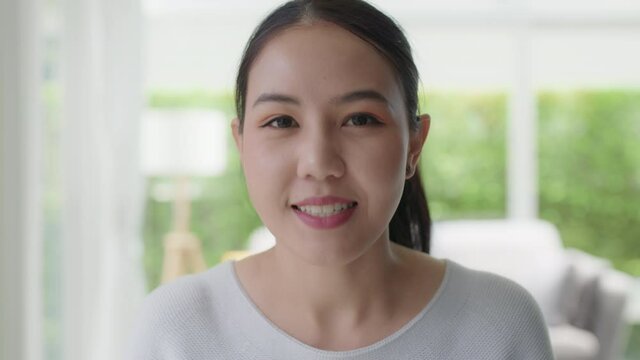 POV selfie screen asian woman youtuber vlogger talk on webcam at home.