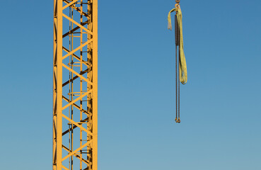 Crane construction tower with yellow steel bars suitable for industrial and building illustrational purposes
