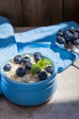 Morning fresh breakfast made from natural products from cottage cheese and blueberries.