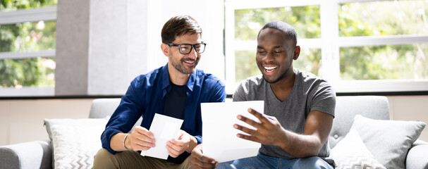 Happy Gay Couple Reading Letter