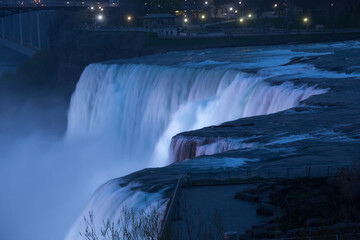 Niagara Falls at night under colored lights