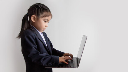 Asian girls use computers to study online.