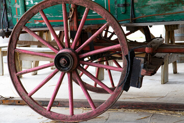 Fototapeta na wymiar Close up of an old red hay wagon wheel and rubber brake