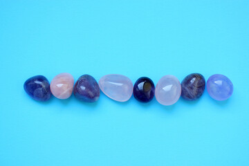 Gems of various colors. Amethyst and rose quartz on blue background.