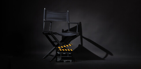 Black director chair and Clapperboard or movie slate use in video production or movie and cinema industry. It's black and yellow color.. - obrazy, fototapety, plakaty