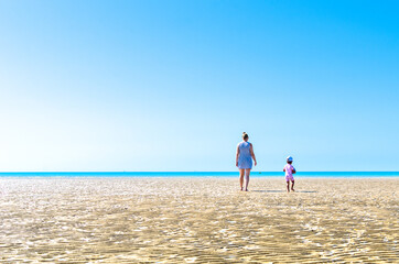 Mother and child at Camber Sands beach in summer, East Sussex, England