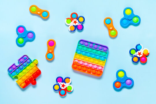 Set of antistress toys Pop It Simple Dimple on blue backgrouund. Trendy fidget toy