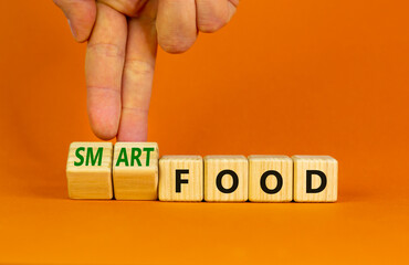 Smart food symbol. Doctor turns cubes and changes words 'food' to 'smart food'. Beautiful orange background. Medical, smart food concept. Copy space.