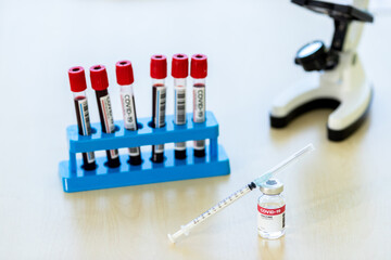 Room test tubes and lab samples of coronavirus diagnostic blood test mock-up bottle of covid-19 vaccine microscope in medical research laboratory or science laboratory study for preventive vaccination