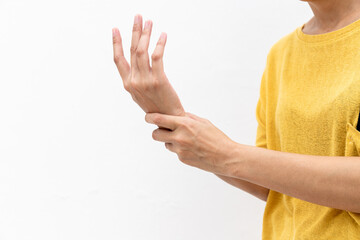 Woman in yellow clothes using hand to hold wrist with feeling pain, suffer, hurt and tingling. Concept of Guillain barre syndrome and numb hands disease.